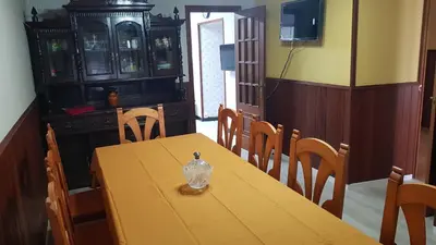 a dining room with a table with a glass jar on it at CASA LOZANO in Barreiros