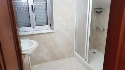 a bathroom with a toilet and a sink and a shower at CASA LOZANO in Barreiros