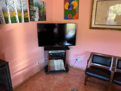 a living room with a flat screen tv on a wall at Casa Río Miño CORTEGADA in Cortegada
