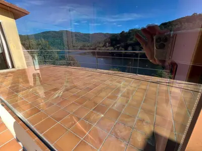 a balcony with a view of the water and mountains at Casa Río Miño CORTEGADA in Cortegada