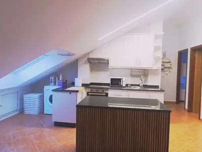 a kitchen with white cabinets and a counter top at Apartamento Rio Gallo II in Cuntis