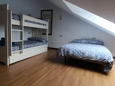 a bedroom with two bunk beds and a staircase at Apartamento Rio Gallo II in Cuntis