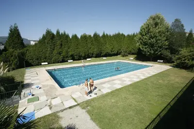 a group of people standing around a swimming pool at Apartamento Rio Gallo II in Cuntis