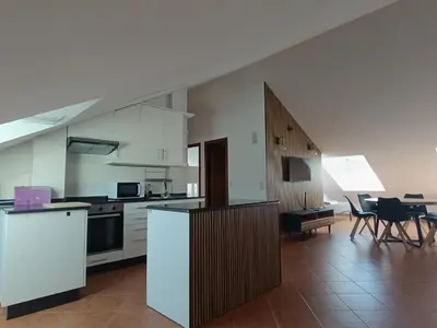 a kitchen with white cabinets and a table and chairs at Apartamento Rio Gallo II in Cuntis