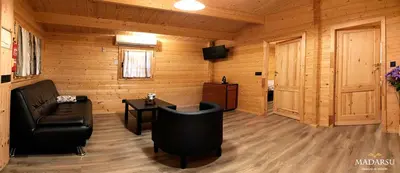 a living room with a couch and a table at Cabañas Madarsu in Vigo de Sanabria