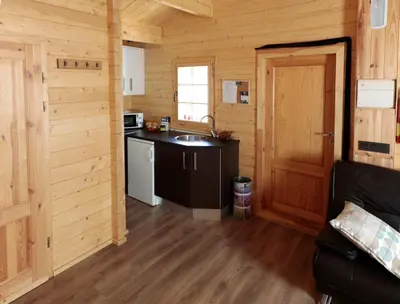 a kitchen in a log cabin with a sink at Cabañas Madarsu in Vigo de Sanabria