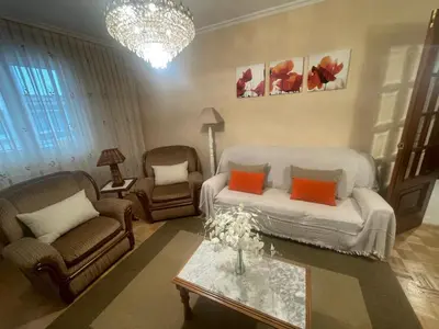 a living room with a couch and chairs and a table at Piso Ainoa Playa de Covas in Viveiro