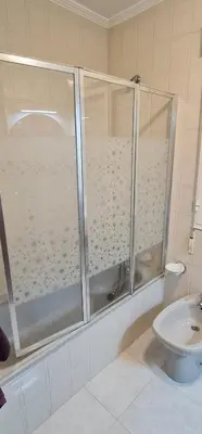 a bathroom with a shower and a toilet at Piso Ainoa Playa de Covas in Viveiro