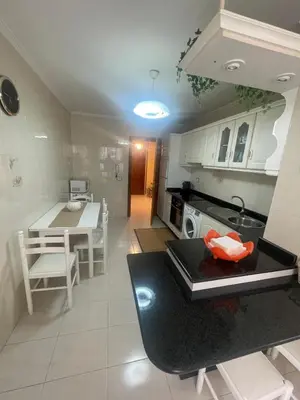 a kitchen with a table and a dining room at Piso Ainoa Playa de Covas in Viveiro