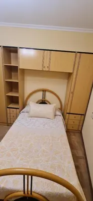 a bedroom with a bed with a pillow on it at Piso Ainoa Playa de Covas in Viveiro