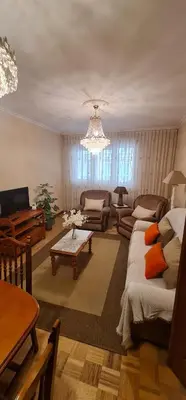 a living room with a couch and a chandelier at Piso Ainoa Playa de Covas in Viveiro