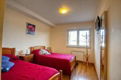 a bedroom with two beds and a window at Pension Escalinata in Sarria