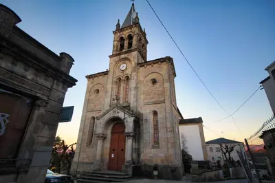 an old church with a clock tower on top of it at Pension Escalinata in Sarria