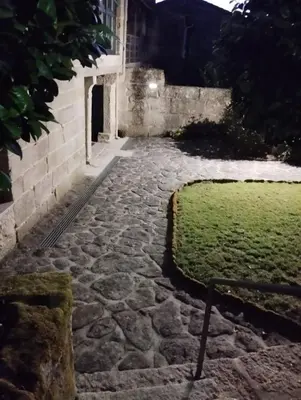a swimming pool in a yard with a hedge at La Casona RibeiraSacra in Moreiras