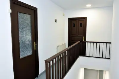 a stairway with a wooden door and a window at O lar Albergue Larouco in Laroco