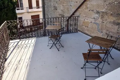 a balcony with two tables and chairs on it at O lar Albergue Larouco in Laroco