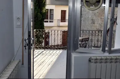 a door to a balcony with a view of a building at O lar Albergue Larouco in Laroco