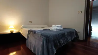 a bedroom with a bed with a table with towels on it at Medorra in Ourense