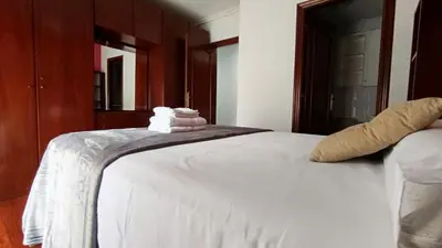 a bedroom with a white bed with towels on it at Medorra in Ourense