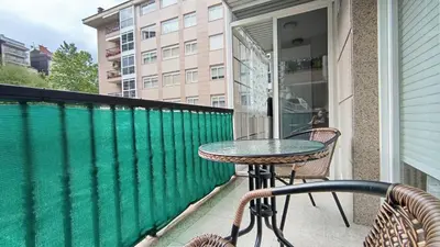 a balcony with a table and chairs on a balcony at Medorra in Ourense