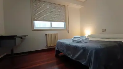 a room with a bed with towels on a table at Medorra in Ourense