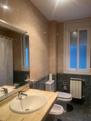 a bathroom with two toilets and a sink at Hotel Berna in La Rúa