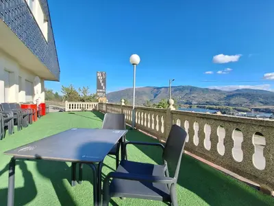 a table and chairs on the balcony of a building at Hotel Berna in La Rúa