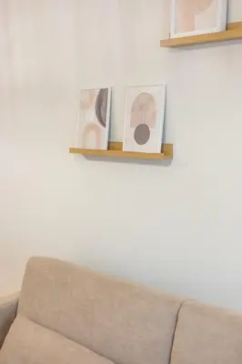 a living room with a couch and two pictures on a wall at Apartamento Ronda Muralla in Lugo