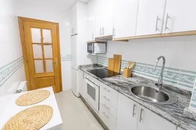 a kitchen with a sink and a counter top at Apartamento Ronda Muralla in Lugo