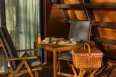 a table and chairs with a meal on it at EcoCamp San Román by SuitesNature in Lugo