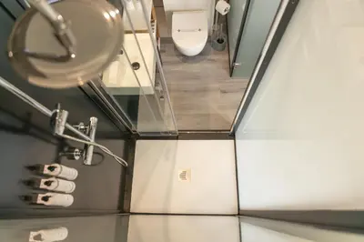 a bathroom with a toilet and a sink at EcoCamp San Román by SuitesNature in Lugo