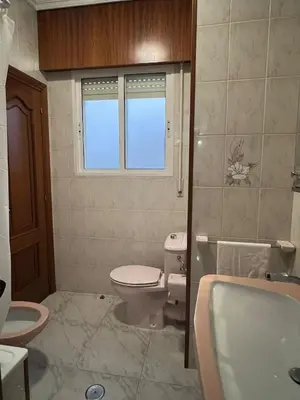 a bathroom with a toilet and a sink at Playa Centro Miño in Miño