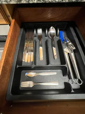 a tray with silver utensils in a drawer at Playa Centro Miño in Miño