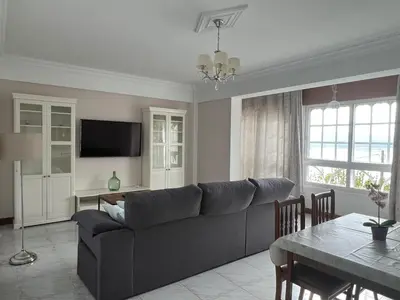 a living room with a couch and a table at Playa Centro Miño in Miño