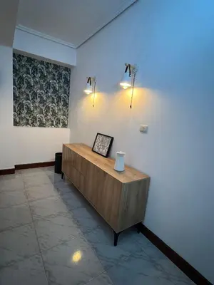 a room with a table and lights on a wall at Playa Centro Miño in Miño