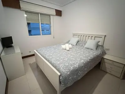 a bedroom with a bed with two pillows on it at Playa Centro Miño in Miño