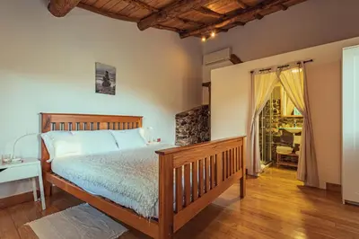 a bedroom with a bed and a table and a doorway at Cabo Do Mundo Casa Rural in Chantada