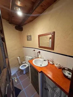 a bathroom with a sink and a toilet at Casa Redonda in Ourense