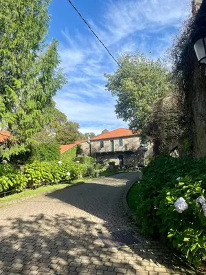 a cobblestone road in front of a house at Casa Redonda in Ourense