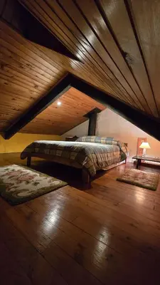a bedroom with two beds and a wooden ceiling at Casa Redonda in Ourense
