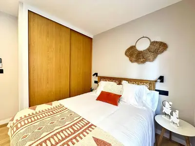 a bedroom with a large bed with a wooden headboard at Os Potes Bajo in Ares