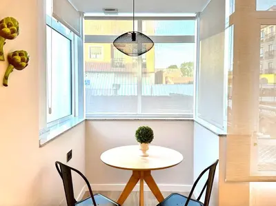 a table and chairs in a room with a window at Os Potes Bajo in Ares