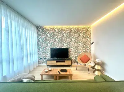 a living room with a tv and a couch and a table at Os Potes Bajo in Ares