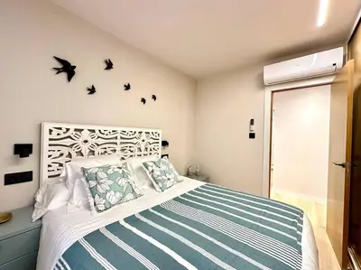 a bedroom with a bed with birds on the wall at Os Potes Flat in Ares