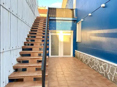 a staircase leading up to a door on a building at Os Potes Flat in Ares