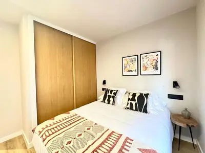 a bedroom with a large bed with a wooden headboard at Os Potes Flat in Ares