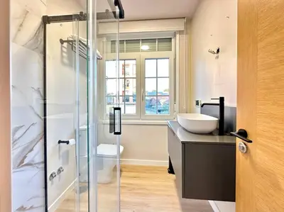 a bathroom with a sink and a glass shower at Os Potes Flat in Ares