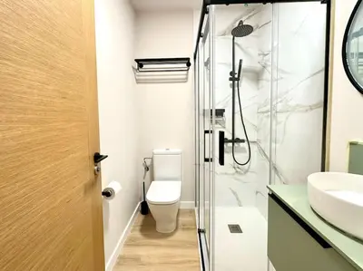 a bathroom with a shower and a toilet and a sink at Os Potes Flat in Ares
