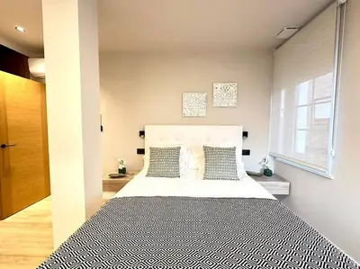 a bedroom with a large bed and a window at Os Potes Flat in Ares