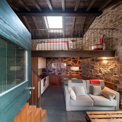a living room with a couch and a table at Casa Peón de Pardaces in Santiago de Compostela